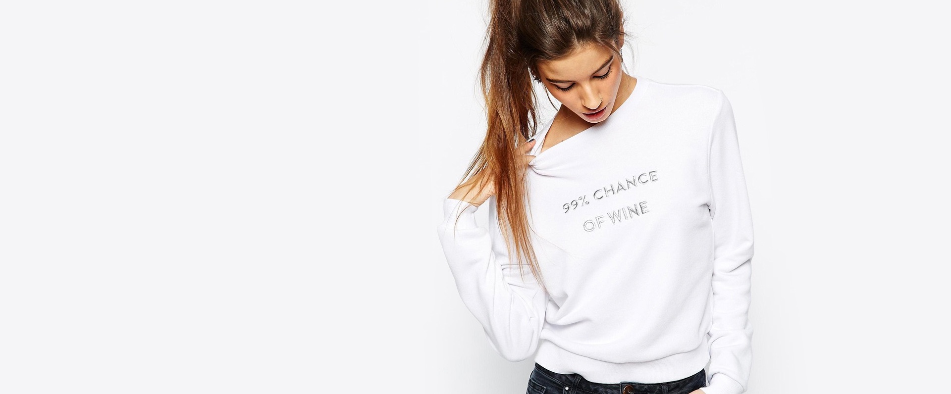 model posing with white long sleeved shirt with words ninety-nine percent chance of wine